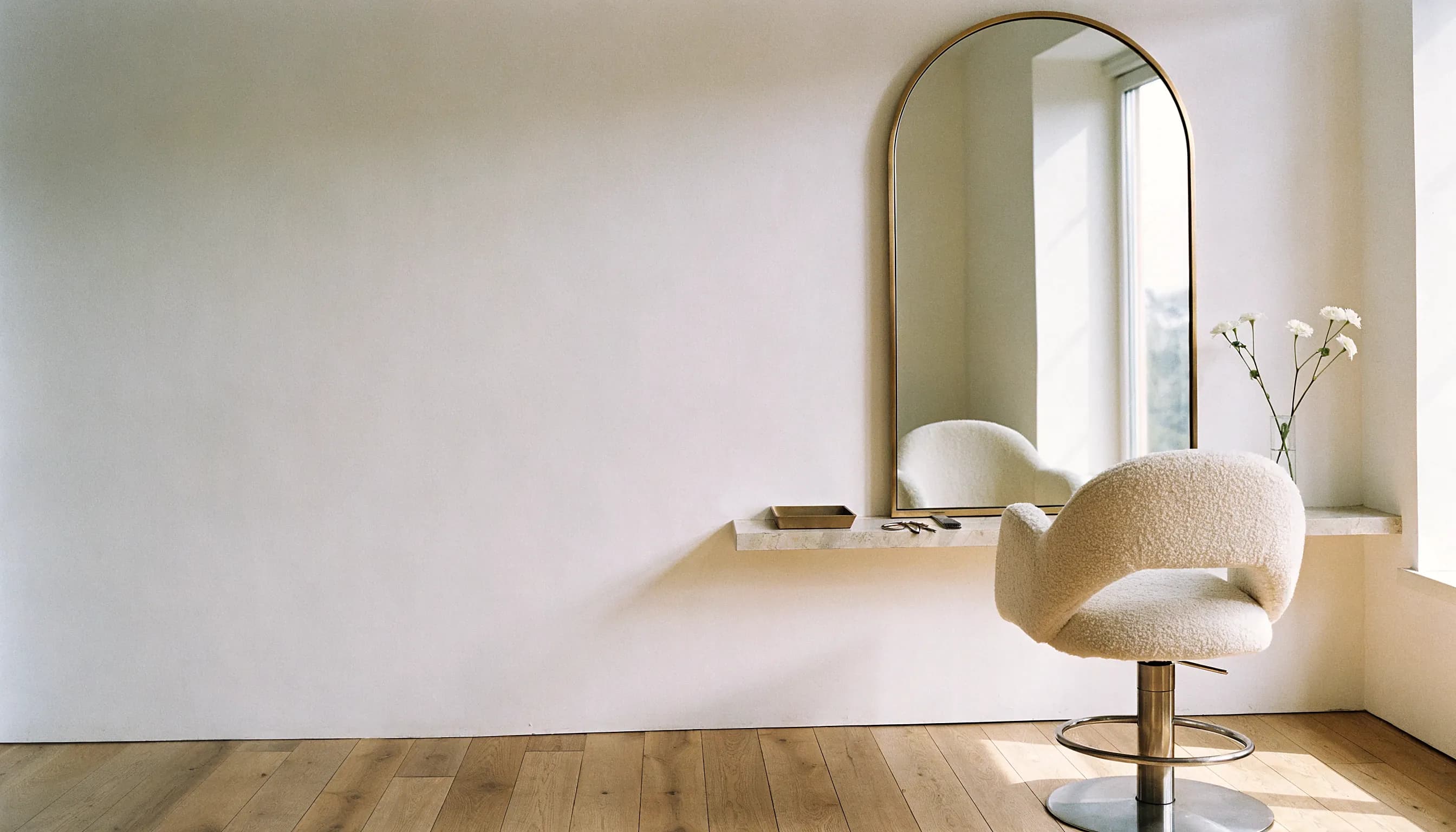 An elegant hair studio in early morning light, empty before the first client